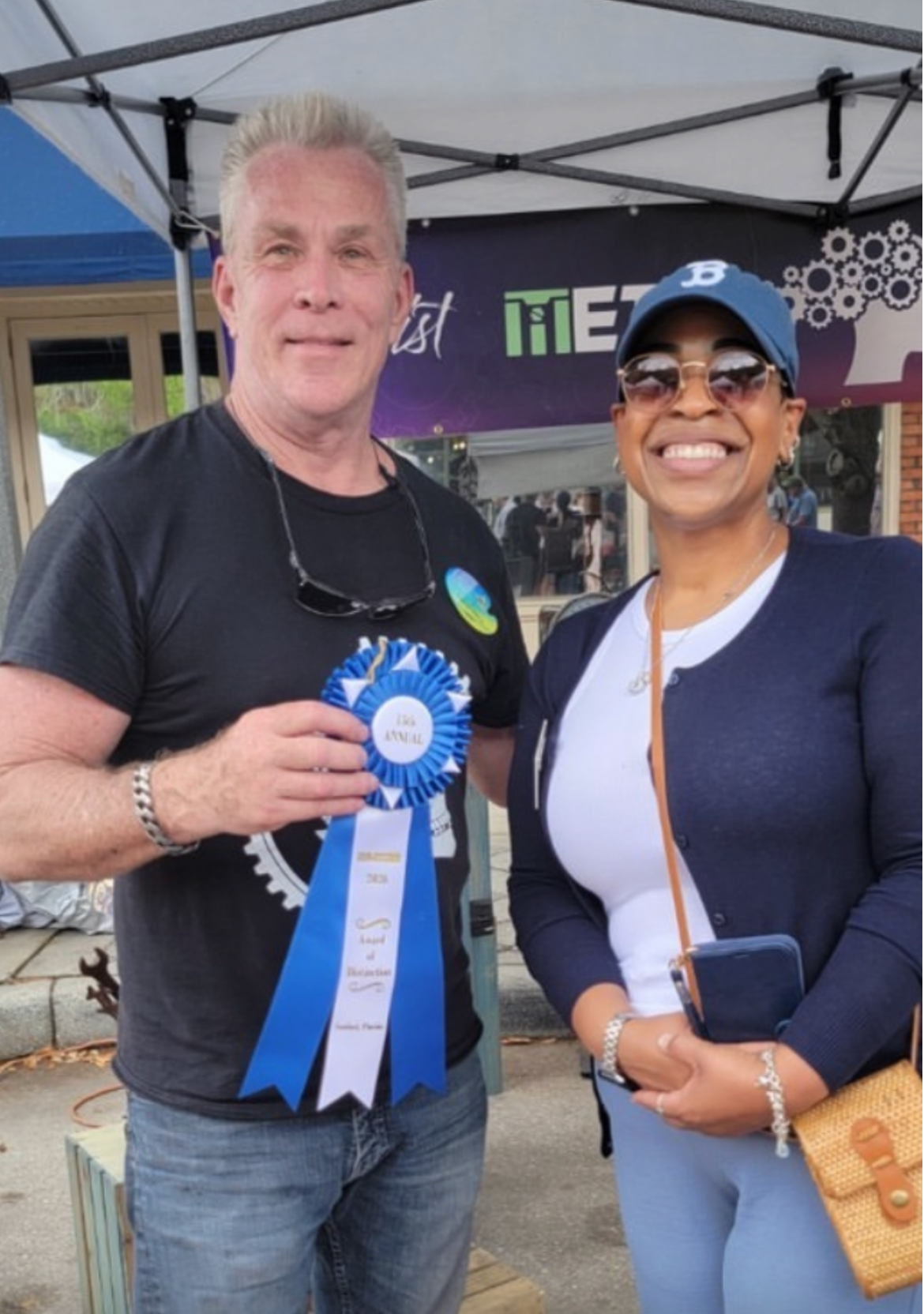Charles Volkema holding his Award of Distinction ribbon at the St. Johns River Art Fest